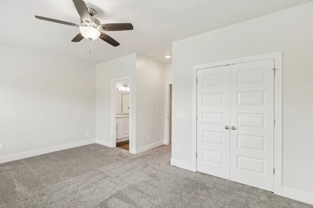 an empty room with fan and entrance