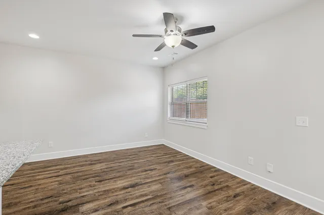 wooden floor in an empty room with a window