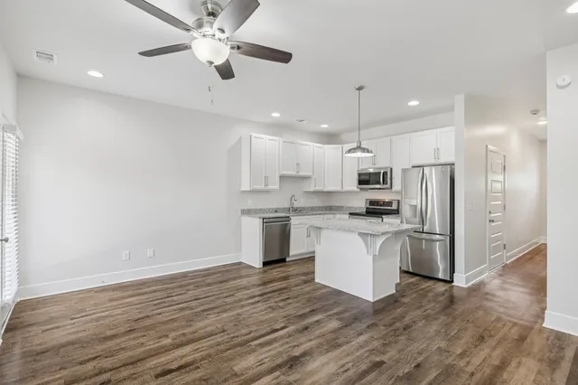 a kitchen with a refrigerator and a sink