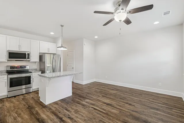 a view of kitchen with sink microwave and stove
