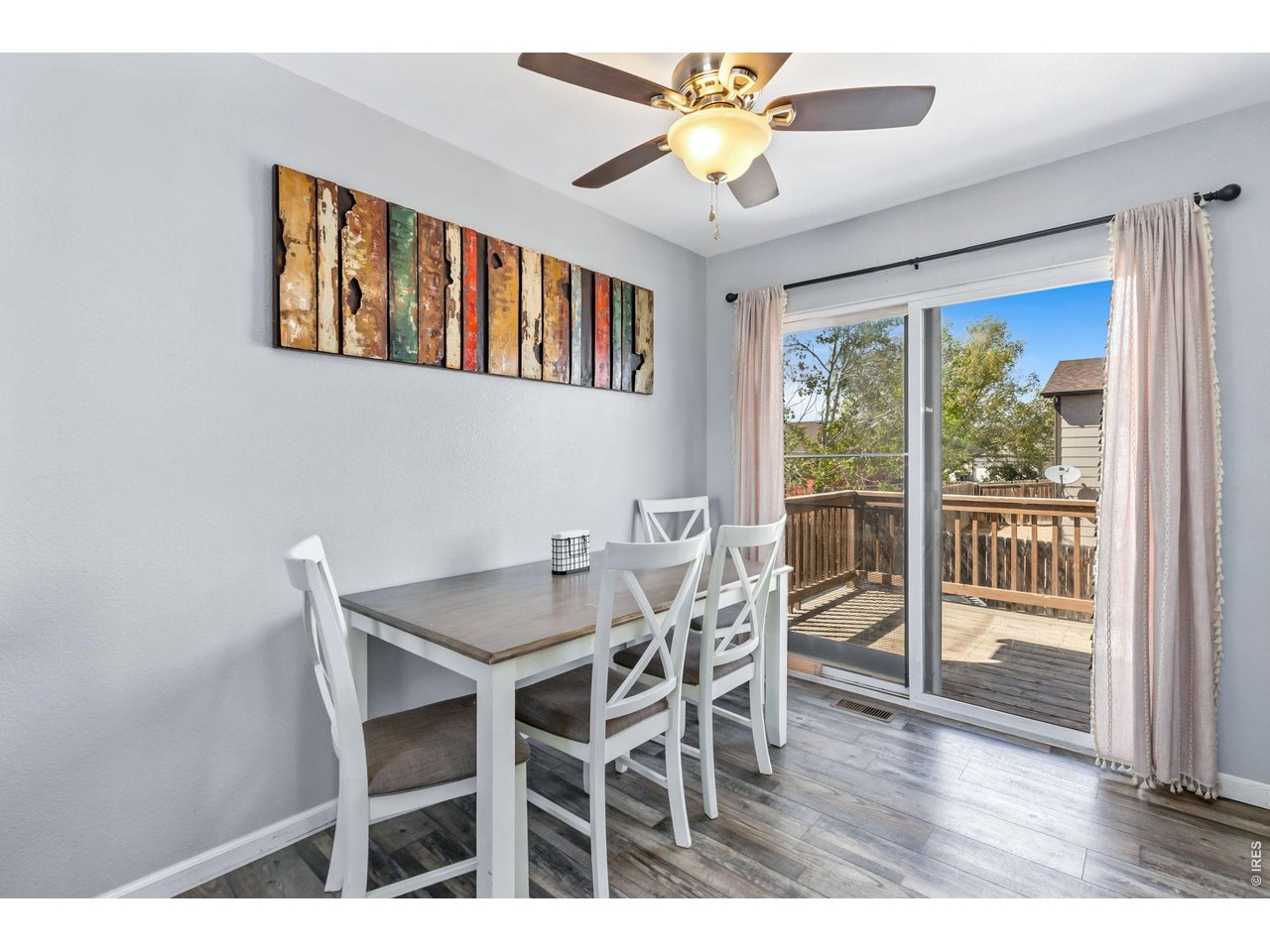 233 East 19th Street Road Greeley, CO 80631 - Photo 6 of 22 a view of a dining room with furniture a chandelier and wooden floor