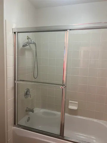 a bathroom with a shower and a bath tub
