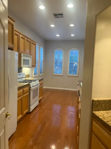 a kitchen with stainless steel appliances granite countertop a stove and a refrigerator