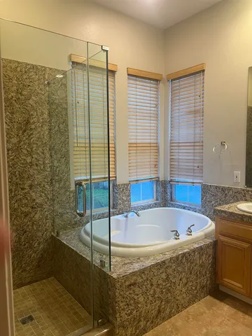 a bathroom with a bathtub and shower