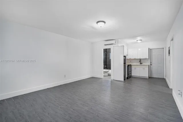 a view of a kitchen with a sink and a refrigerator