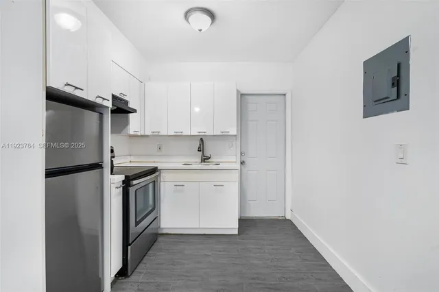 a kitchen with stainless steel appliances granite countertop a refrigerator sink and stove