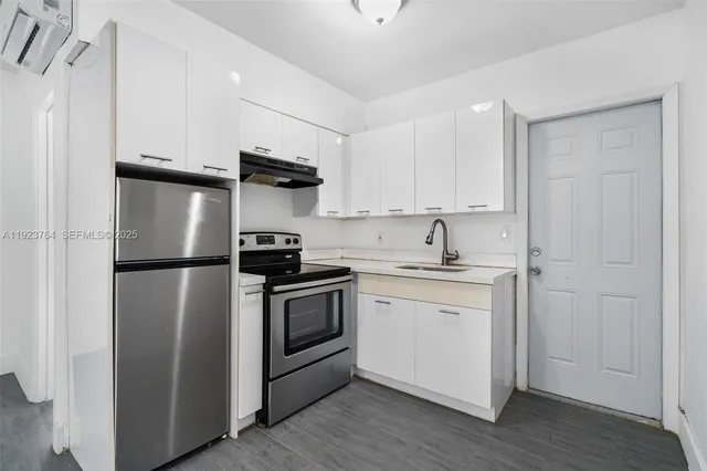 a kitchen with a refrigerator stove and sink