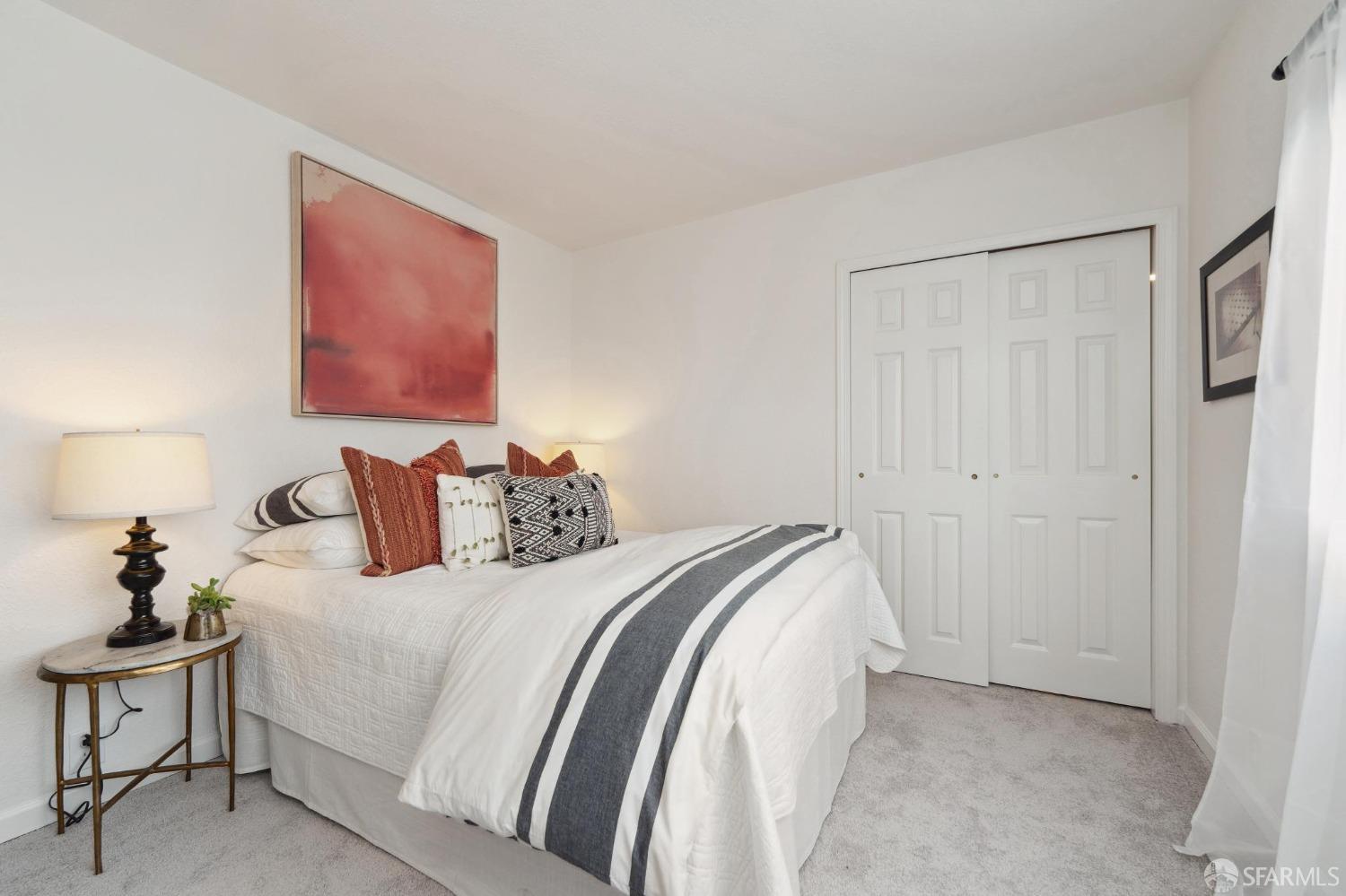 512 Macarthur Drive Daly City, CA 94015 - Photo 36 of 53 a bedroom with bed a mirror and a lamp