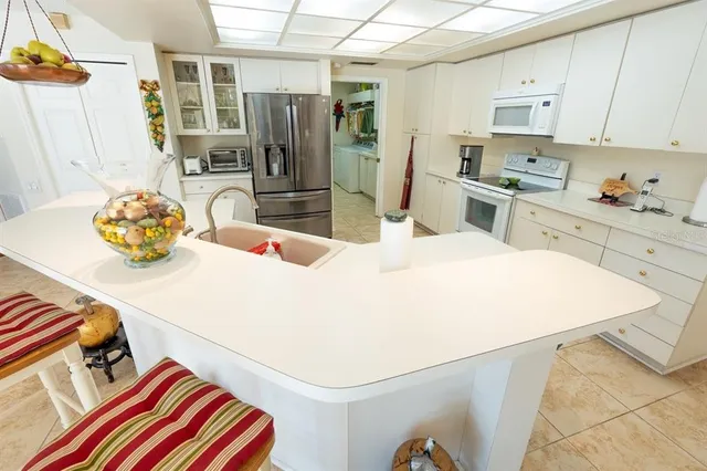 a kitchen with stainless steel appliances kitchen island granite countertop a sink and cabinets