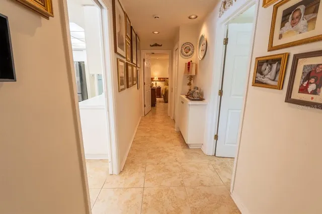 a view of a hallway with wooden floor and cabinets