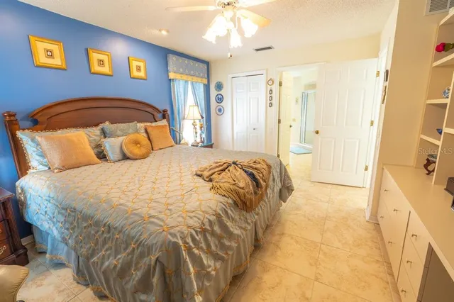 a bedroom with a bed and a mirror