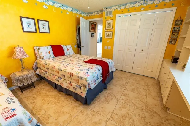 a bedroom with a bed and a dresser