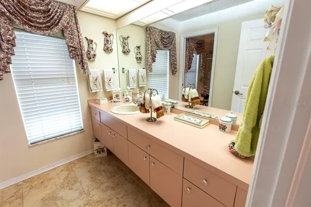 a bathroom with a double vanity sink and a mirror
