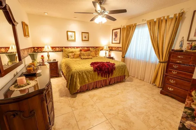 a bedroom with a bed and a flat tv screen