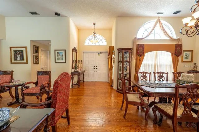 a view of a a dining room with furniture window and wooden floor