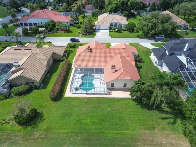 an aerial view of house with swimming pool outdoor seating and yard