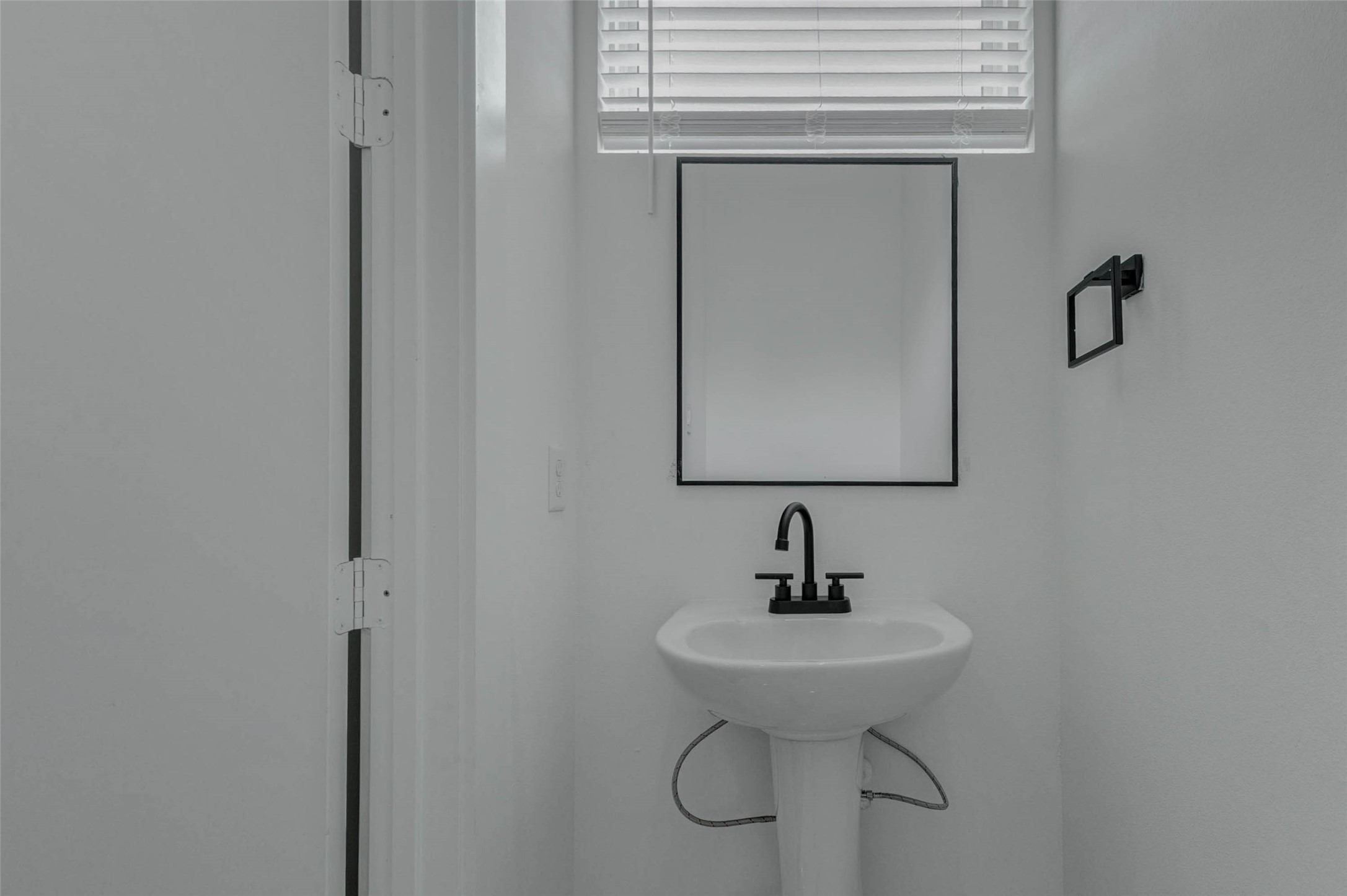 5705 Elysium Street Houston, TX 77091 - Photo 16 of 22 The half bath features a compact modern vanity, clean finishes, and a simple, polished look that serves the main living level conveniently.