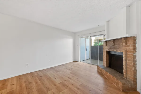 a view of an empty room with a fireplace