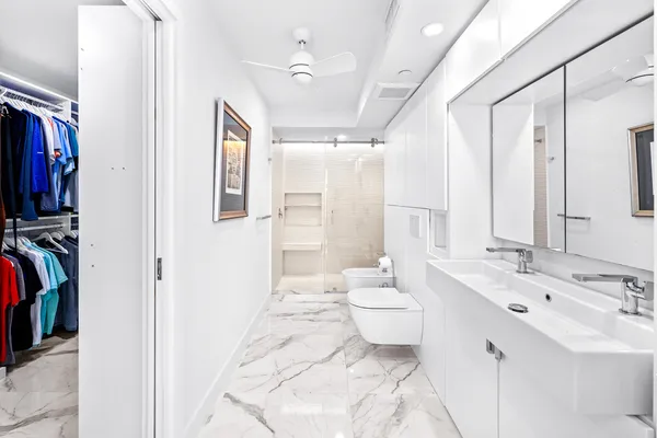 a bathroom with a double vanity sink toilet and shower