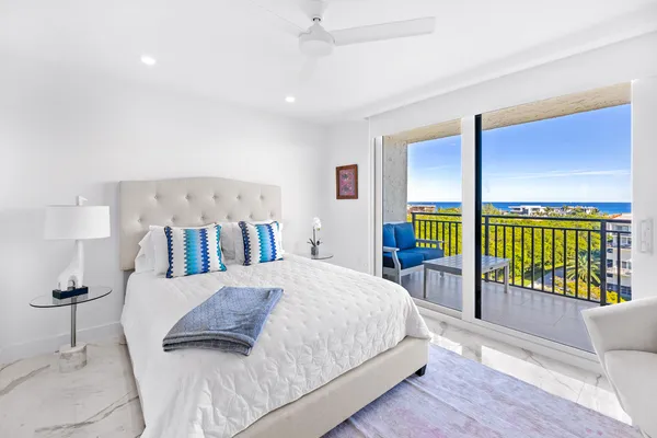 a bedroom with a large bed and a night stand