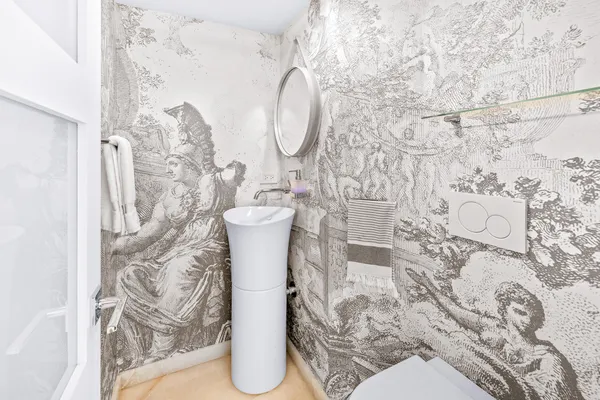 a white toilet sitting next to a shower curtain