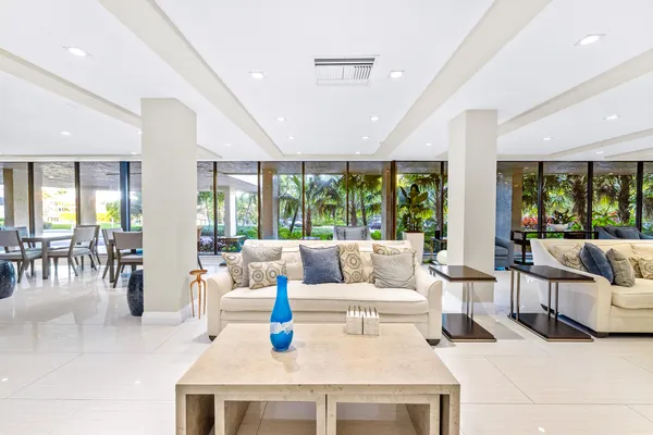 a living room with furniture and large windows