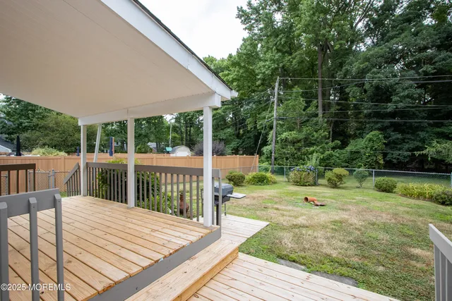 a view of a backyard with a deck and wooden floor