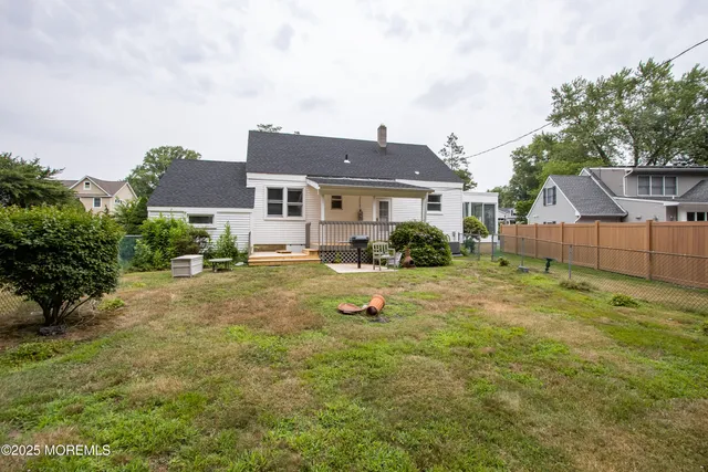 a backyard of a house with yard and outdoor seating
