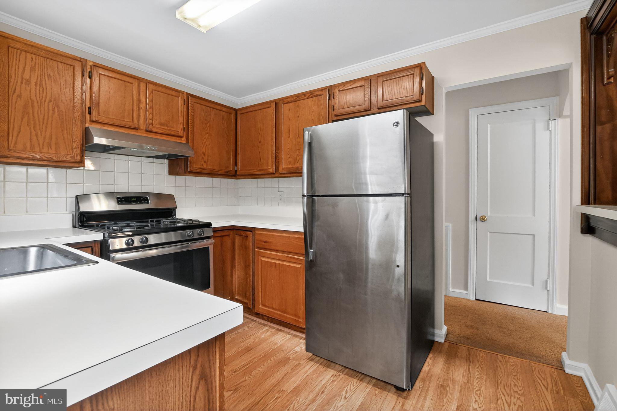 276 Valley View Road Malvern, PA 19355 - Photo 4 of 15 a kitchen with a refrigerator sink and cabinets