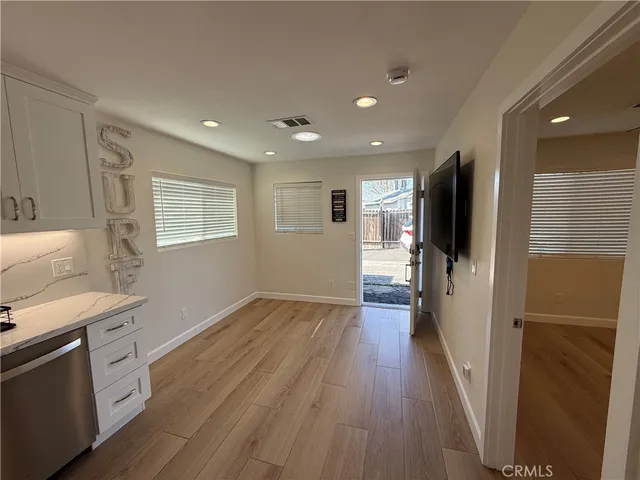 a view of a kitchen cabinets wooden floor and a kitchen
