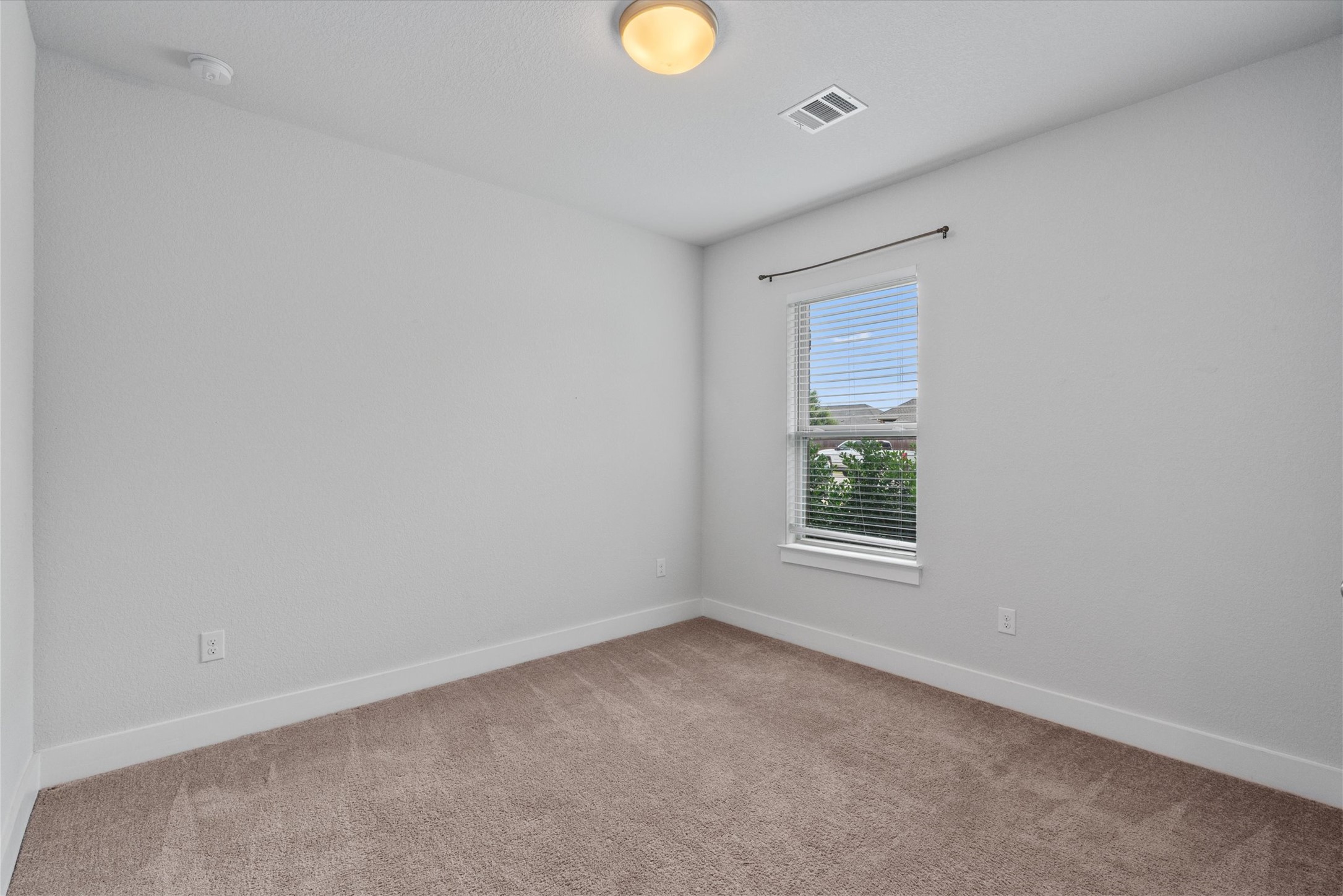 941 Del Raphael Drive Leander, TX 78641 - Photo 16 of 31 The first guest bedroom gets great natural light and sits well away from the primary suite for maximum privacy