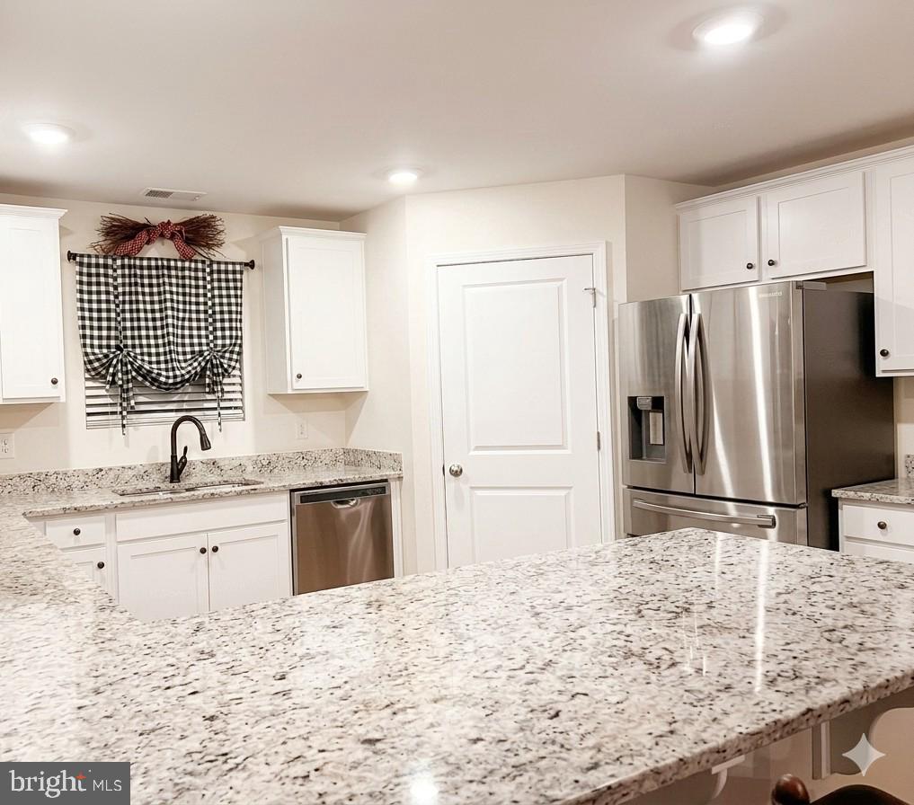 17854 Meriwether Lewis Street Ruther Glen, VA 22546 - Photo 8 of 35 a kitchen with stainless steel appliances granite countertop a refrigerator and a sink