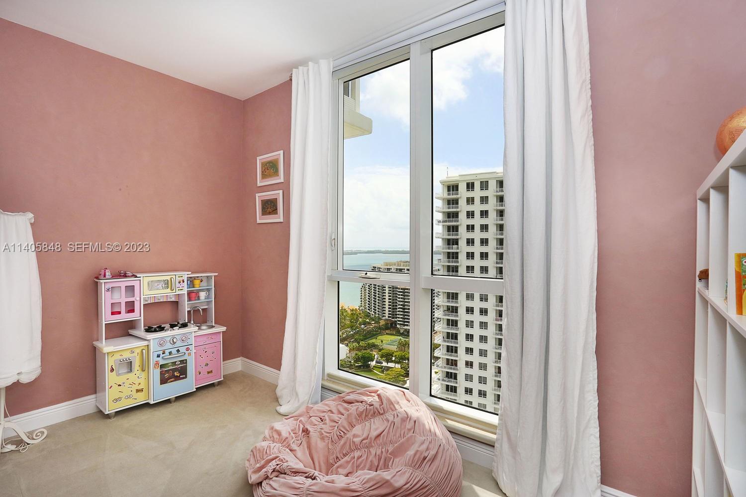 901 Brickell Key Boulevard, Unit 2903 Miami, FL 33131 - Photo 19 of 31 a bedroom with furniture and a large window