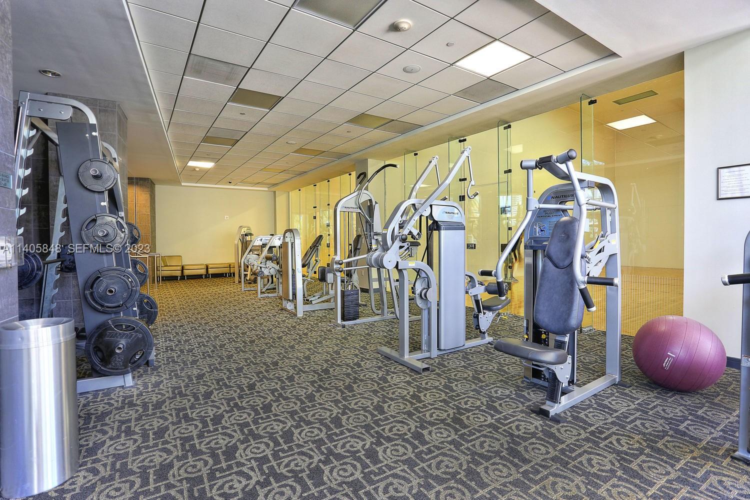 901 Brickell Key Boulevard, Unit 2903 Miami, FL 33131 - Photo 26 of 31 a view of a room with gym equipment
