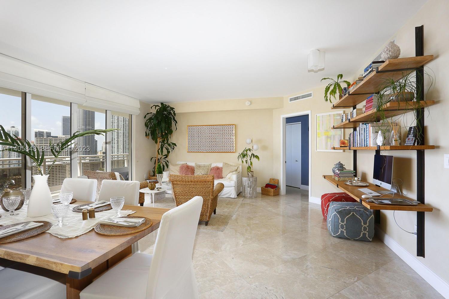 901 Brickell Key Boulevard, Unit 2903 Miami, FL 33131 - Photo 4 of 31 a view of a livingroom with furniture and a flat screen tv