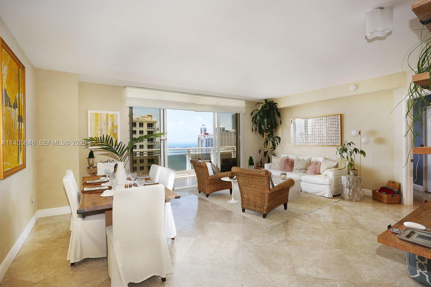 901 Brickell Key Boulevard, Unit 2903 Miami, FL 33131 - Photo 5 of 31 a living room with furniture a couch and a potted plant