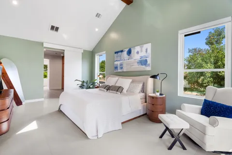 a bed room with a bed and a chair