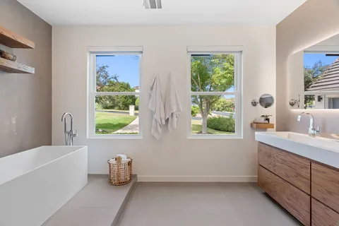 a bathroom with a tub sink and window