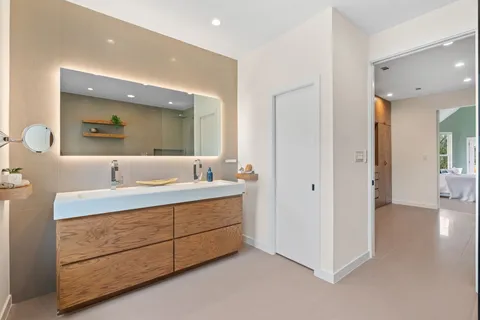 a bathroom with a double vanity sink and mirror