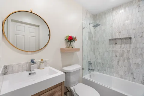 a bathroom with a sink toilet and a mirror