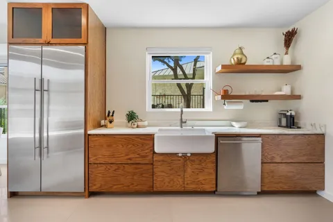 a kitchen with a refrigerator and a sink