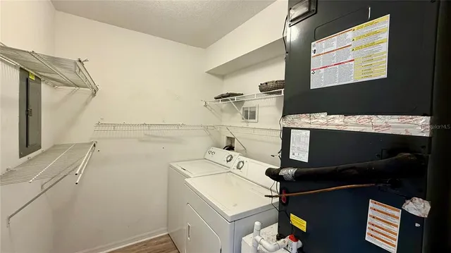 a view of a swimming pool with a patio and a yard