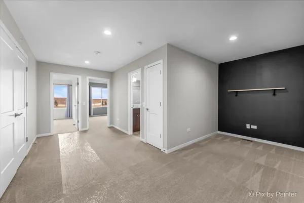 an empty room with closet and wooden floor