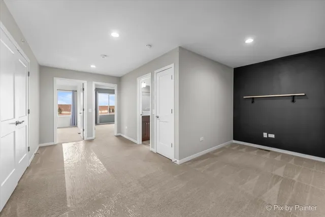 an empty room with closet and wooden floor