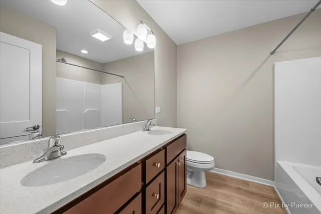 a bathroom with a sink a toilet a mirror and vanity