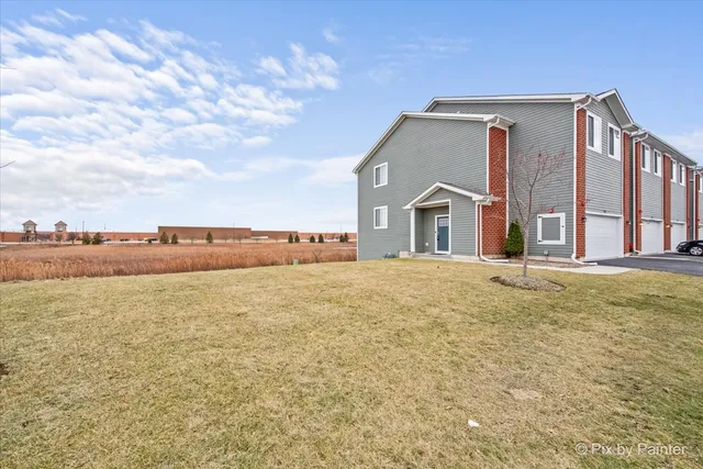 a view of a big house with a yard