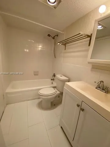 a bathroom with a toilet a sink and bathtub