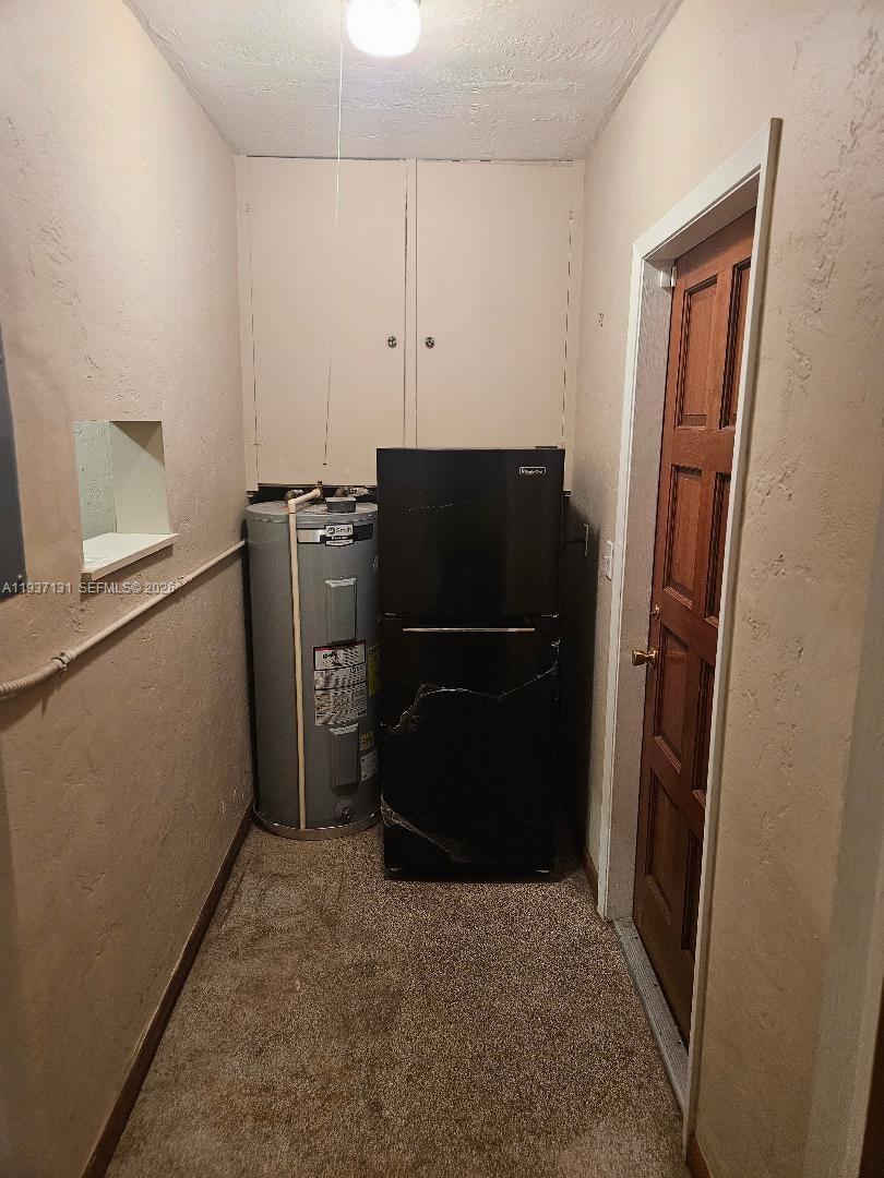 5842 Harding Street, Unit R Hollywood, FL 33021 - Photo 2 of 5 a kitchen with a refrigerator freezer and a dishwasher