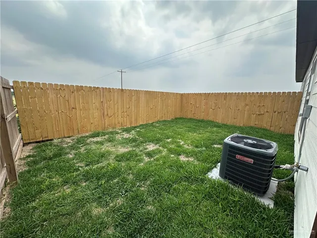 a view of a backyard with wooden fence