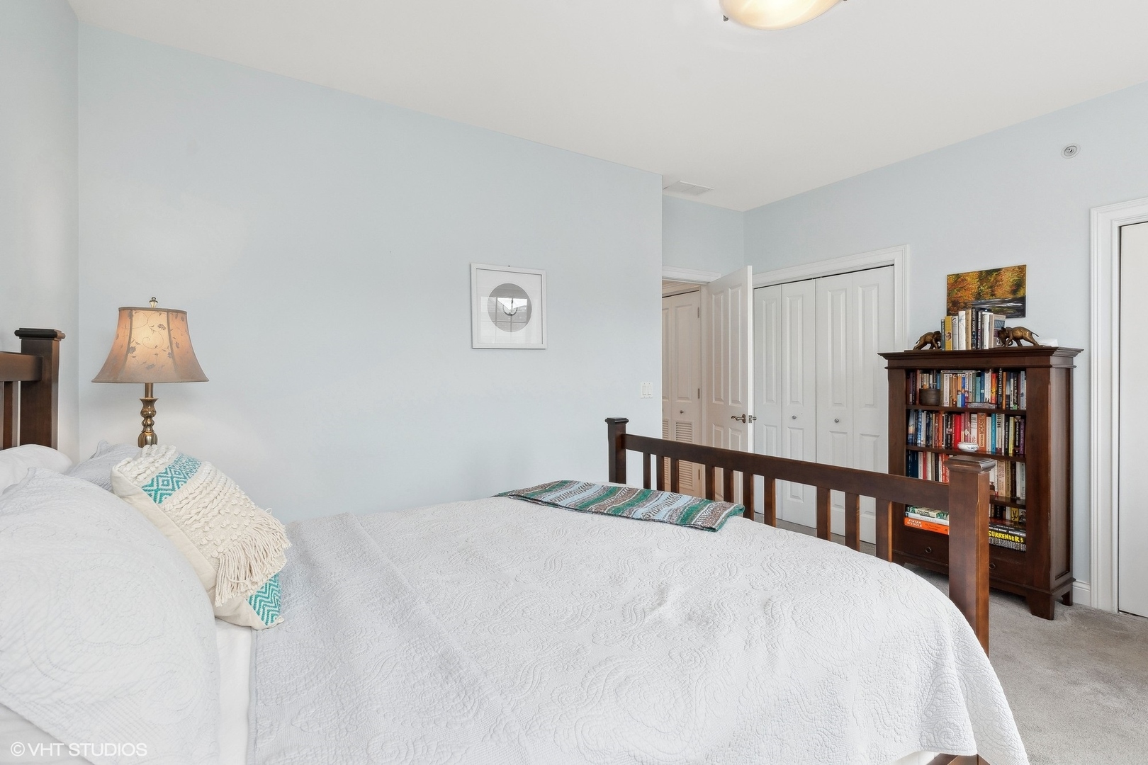 3003 West Cornelia Avenue Chicago, IL 60618 - Photo 12 of 25 a bedroom with a bed and a book shelf